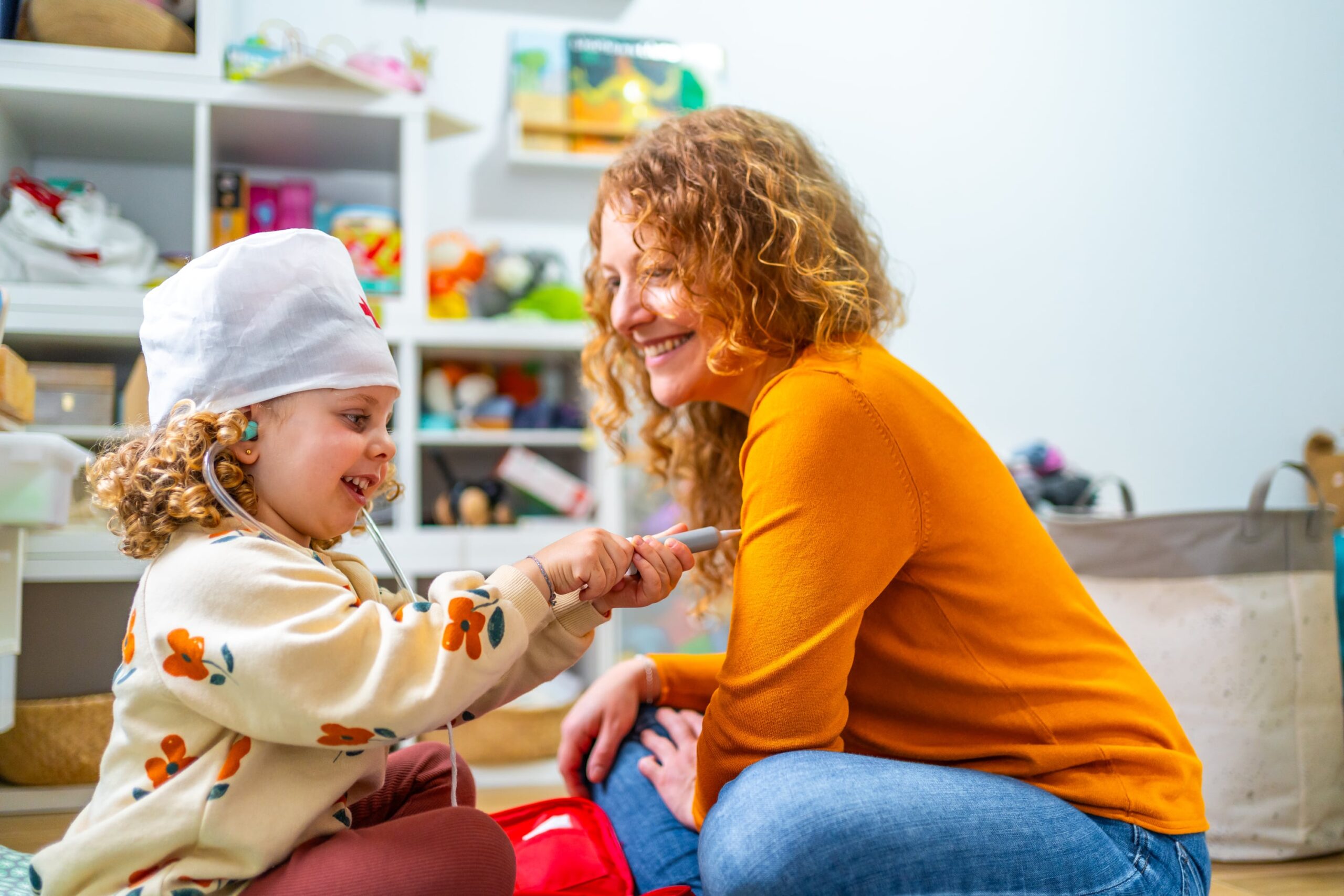 Mother and daughter playing pretend doctor
